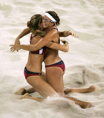 Kerri Walsh and Misty May hugging in the sand.